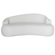 A modern curved beige sofa with a low back and wide armrests, shown against a plain white background.