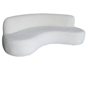 A modern curved beige velvet sofa with a low back and rounded legs, shown against a plain white background.