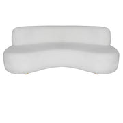 A modern curved white sofa with a low back and small gold-toned feet, shown against a plain white background.