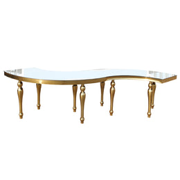 Round S shaped Dinning table with gold legs and a clear glass top on a white background