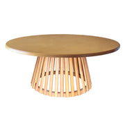 A round wooden dining table with a medium brown top and a light natural wood slatted pedestal base.