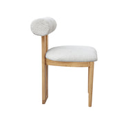 A modern wooden dining chair with a rounded, cylindrical backrest and a thick, textured off-white bouclé seat cushion, shown against a plain white background.
