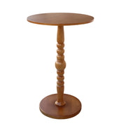 A round wooden pub cocktail table with a turned spindle pedestal base and a circular footstool-style bottom plate.
