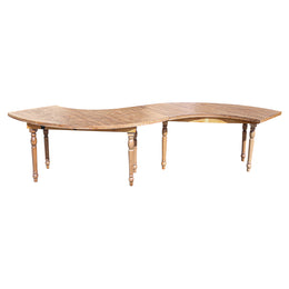Wooden dining table with curved design on a white background